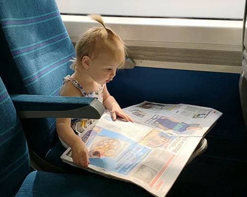 child reading newspaper